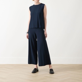 Model wearing Max Mara Weekend Ere Pliss&eacute; Top in navy, styled with matching wide-leg pliss&eacute; trousers and black loafers.
