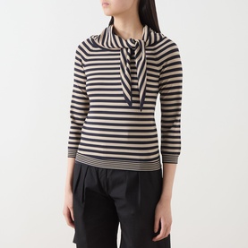 Model wearing Max Mara Main stone stripe top with bow neck detail and three-quarter sleeves, styled with black trousers.
