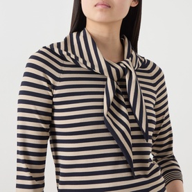 Model wearing Max Mara Main stone and navy stripe top with scarf neckline tie detail, three-quarter sleeves, close-up view.