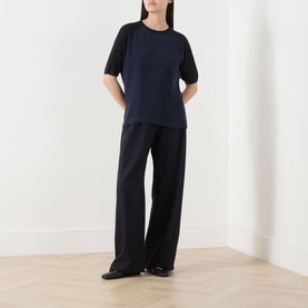 Model wearing Max Mara Main Golfo Two-Tone Knitted Sweater in ultramarine with contrasting sleeves, styled with wide-leg black trousers.