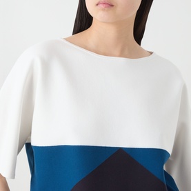 Model wearing Max Mara Main navy colour-block top with white and blue panels, boat neckline and short sleeves.