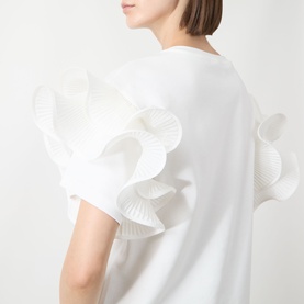 Model wearing Max Mara Main Costone Ruffle T-Shirt in white with voluminous pleated taffeta ruffle sleeve detailing, shown from back