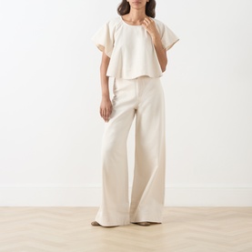 Model wearing Max Mara Weekend ecru cotton top with wide-leg trousers, styled in a relaxed co-ord look