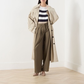 Model wearing Max Mara Main Voto Striped Sweater in Ultramarine, cropped knit with navy stripes, styled with beige trench coat and olive wide-leg