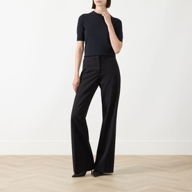 Model wearing Max Mara Main Aceti Silk-Cashmere Knit Sweater in Ultramarine, crew neck, short sleeves, styled with wide-leg black trousers