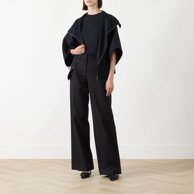 Model wearing Max Mara Main Aceti Silk-Cashmere Knit Sweater in Ultramarine, styled with a dark cape, wide-leg trousers and black heels.