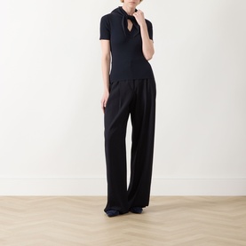 Model wearing Max Mara Main Palmeti Scarf Top in Ultramarine with detachable neck scarf, styled with wide-leg black trousers
