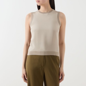 Model wearing Max Mara Main Ginseng Knitted Vest in stone, crew neck sleeveless knit with contrast panel trim, styled with olive wide-leg trousers