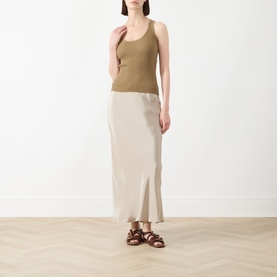Model wearing Max Mara Main kaki viscose tank top, styled with a beige midi skirt and brown strappy sandals.