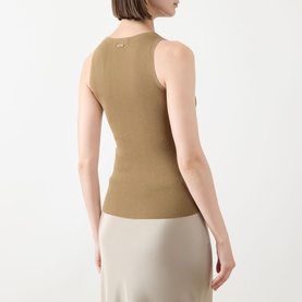 Model wearing Max Mara Main kaki sleeveless ribbed vest top, back view, styled with a cream midi skirt.