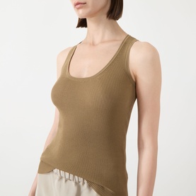 Model wearing Max Mara Main kaki ribbed viscose tank top with scoop neck and wide straps, styled with cream wide-leg trousers.