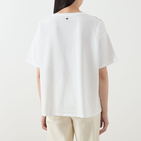 Model wearing Max Mara Weekend Terzo Silk Waterscape T-Shirt in light blue, rear view showing logo detail at back of neck, styled with cream trousers