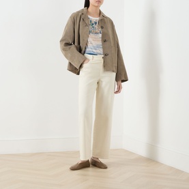 Model wearing Max Mara Weekend Terzo Silk Waterscape T-Shirt in light blue, styled with a tan cropped jacket and cream wide-leg trousers.