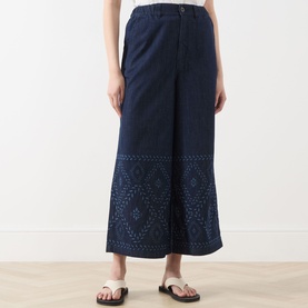 Model wearing Max Mara Weekend Lampada Bandana Print Culottes in Navy Denim, wide-leg cropped style with bandana print hem detail, styled with black