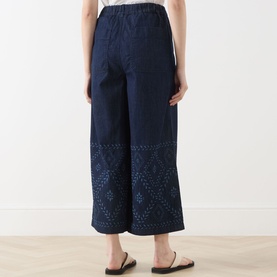 Model wearing Max Mara Weekend Lampada Culottes in Navy Denim, wide-leg cropped fit with eyelet bandana print hem detail, styled with flat sandals
