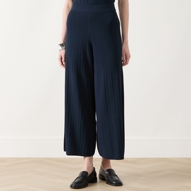 Model wearing Max Mara Weekend navy ribbed wide-leg trousers, styled with black loafers