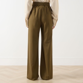 Model wearing Max Mara Main Editto Wide-Leg Trousers in kaki, showing rear elasticated high-rise waist and wide-leg silhouette, styled with cream
