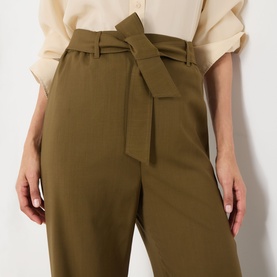 Model wearing Max Mara Main Editto Wide-Leg Trousers in kaki, showing wide-leg silhouette, side pocket and elasticated waistband detail