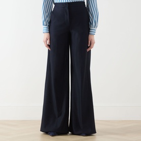 Model wearing Max Mara Main ultramarine wide-leg cotton trousers, styled with a blue striped shirt.