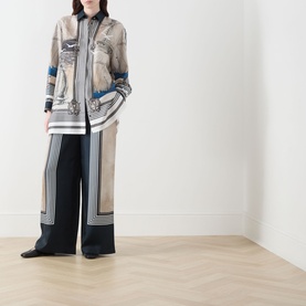 Model wearing Max Mara Main Carabo Printed Wide Leg Trousers in Ultramarine silk-twill, styled with a matching printed silk shirt.