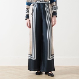 Model wearing Max Mara Main Carabo Printed Wide Leg Trousers in Ultramarine, wide-leg silk-twill with geometric border print, styled with matching