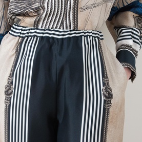 Model wearing Max Mara Main Carabo Printed Wide Leg Trousers in ultramarine with vertical stripe rope print, elasticated waist and side pockets
