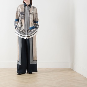 Model wearing Max Mara Main Carabo Printed Wide Leg Trousers in Ultramarine silk-twill, styled with a printed longline shirt.