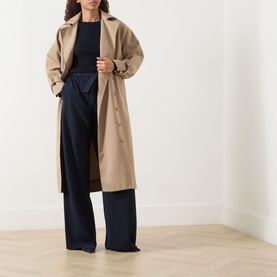 Model wearing Max Mara Main Lira Striped Wide Leg Trousers in Ultramarine, high-waisted wide leg, styled with a beige longline trench coat.