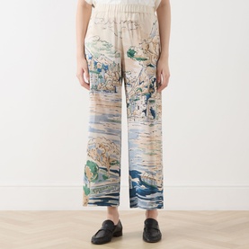 Model wearing Max Mara Weekend light blue scenic print silk wide-leg trousers with elasticated waist, styled with black loafers