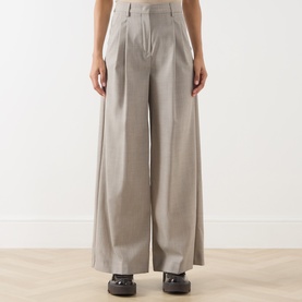 Model wearing Max Mara Weekend Hazelnut wide-leg wool trousers with front pleats, styled with dark chunky-sole shoes.