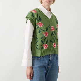 Model wearing Max Mara Weekend Alamaro Floral Knit Vest in Green Floral with pink rose intarsia, V-neck, styled over white shirt with jeans.