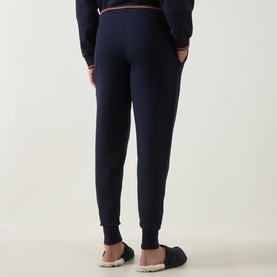 Model wearing Paul Smith Access blue cotton joggers, rear view, elasticated waistband with stripe trim, tapered cuffed ankles