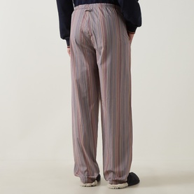 Model wearing Paul Smith Access multicolour striped cotton pyjama bottoms, shown from behind with elasticated waist and straight-leg fit.
