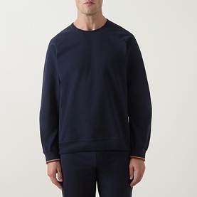 Model wearing Paul Smith Access blue cotton crew neck sweatshirt with signature stripe cuff detail, styled with matching navy loungewear trousers.