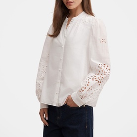Model wearing Forever New Sutton Embroidered Blouse in Porcelain with broderie details and scalloped trim, styled with dark denim jeans.