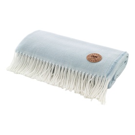 The Lyndon Company Arcadia Throw in blue, folded to show waffle texture, cream fringe trim and branded leather badge.