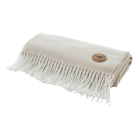 The Lyndon Company Arcadia Throw in Doeskin, folded with fringe trim and branded leather patch detail, textured waffle weave