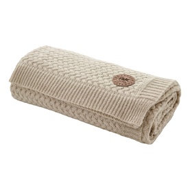 The Lyndon Company Cadenza Throw in cream, folded neatly, featuring a cable-knit weave pattern with a circular woven badge detail.