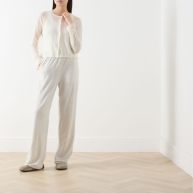 Model wearing AMERICAN VINTAGE Epaky Fine-Knit Cropped Cardigan in ecru, styled with wide-leg trousers and ballet flats
