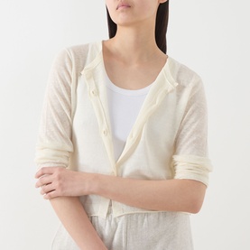 Model wearing American Vintage Epaky Fine-Knit Cropped Cardigan in ecru, styled over white top with matching trousers
