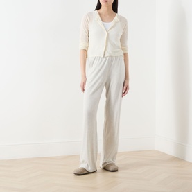 Model wearing American Vintage Epaky Fine-Knit Cropped Cardigan in ecru, styled with wide-leg trousers and slip-on shoes