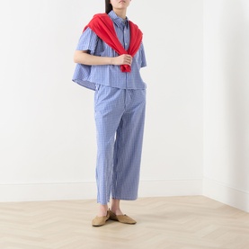 Model wearing AMERICAN VINTAGE shirt in Vichy Bleu check, styled with matching wide-leg trousers, red scarf tied at shoulders, and tan mules.