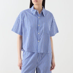 Model wearing American Vintage shirt in Vichy Bleu gingham check, short sleeves, button-down collar, styled with matching trousers