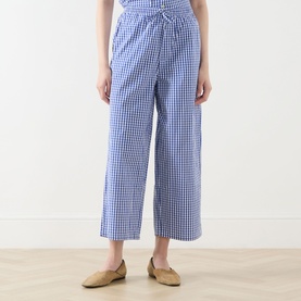 Model wearing American Vintage trousers in Vichy Bleu gingham check, wide-leg cropped cut with elasticated tie waist, styled with nude loafers.