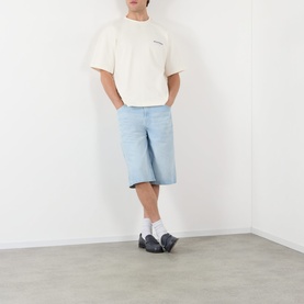 Model wearing About:Blank oat cotton T-shirt styled with light blue denim shorts, white socks and navy shoes.