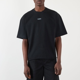 Model wearing About:Blank Raw Hem Ellipse T-Shirt in washed black, round neckline, short sleeves, small chest logo, styled with black trousers.