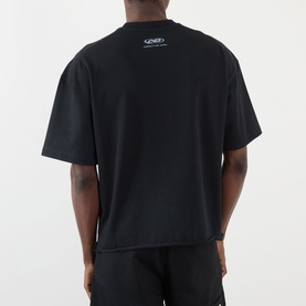 Model wearing About:Blank Raw Hem Ellipse T-Shirt in washed black, back view, with small logo detail at nape and raw hemline.