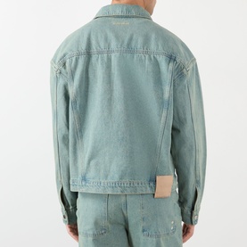Model wearing About:Blank Casual Jacket in murky wash denim, rear view, with matching denim trousers and small label patch at hem.