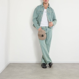 Model wearing About:Blank murky wash cotton casual jacket styled with matching trousers, white tee, and black shoes, holding a beige bag.