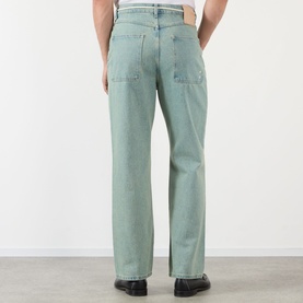 Model wearing About:Blank jeans in murky wash, relaxed straight-leg fit, rear view, styled with black leather shoes.